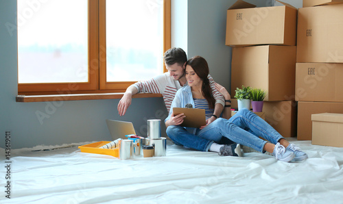 Young couple sitting on the floor of their new apartment