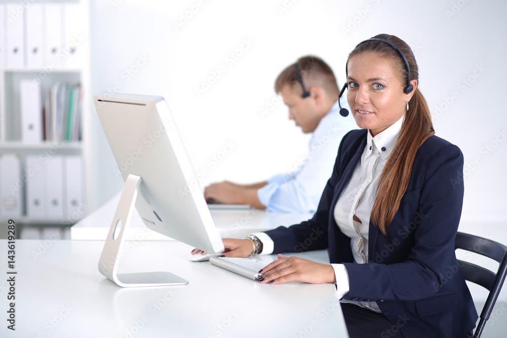 Happy female wearing headset and sitting on the desk Happy female wearing headset and sitting on the desk