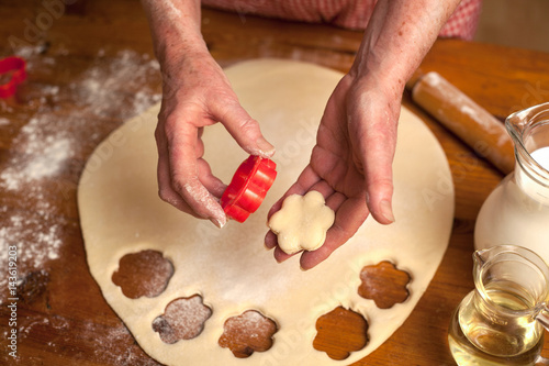 hands of senior woman preparing delicious cookies