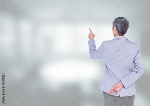 Businesswoman touching air against bright background