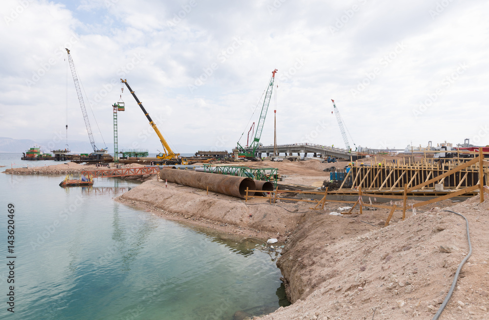 Aqaba, Jordan, 10/10/2015, Cranes working on the foundation construction at the Aqaba new port