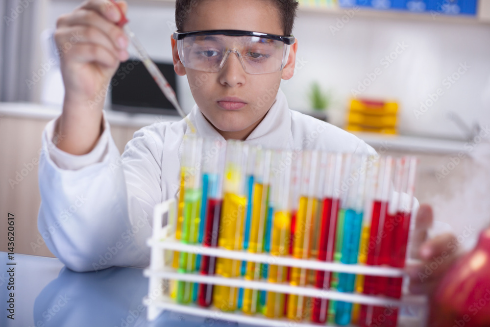 young scientist boy working in a laboratory young scientist boy working in a laboratory
