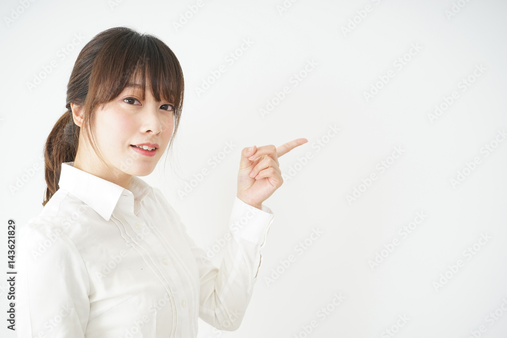 Young business woman pointing something with smile Young business woman pointing something with smile