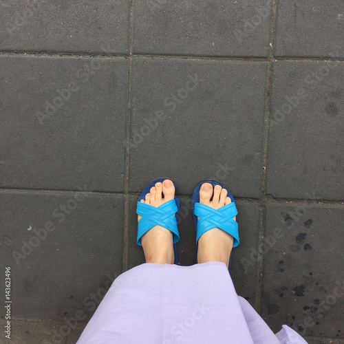Close up of a Woman's Blue Slippers Buddhist Walking on Street or Ground for Relaxation and Meditation Great For Any Use.