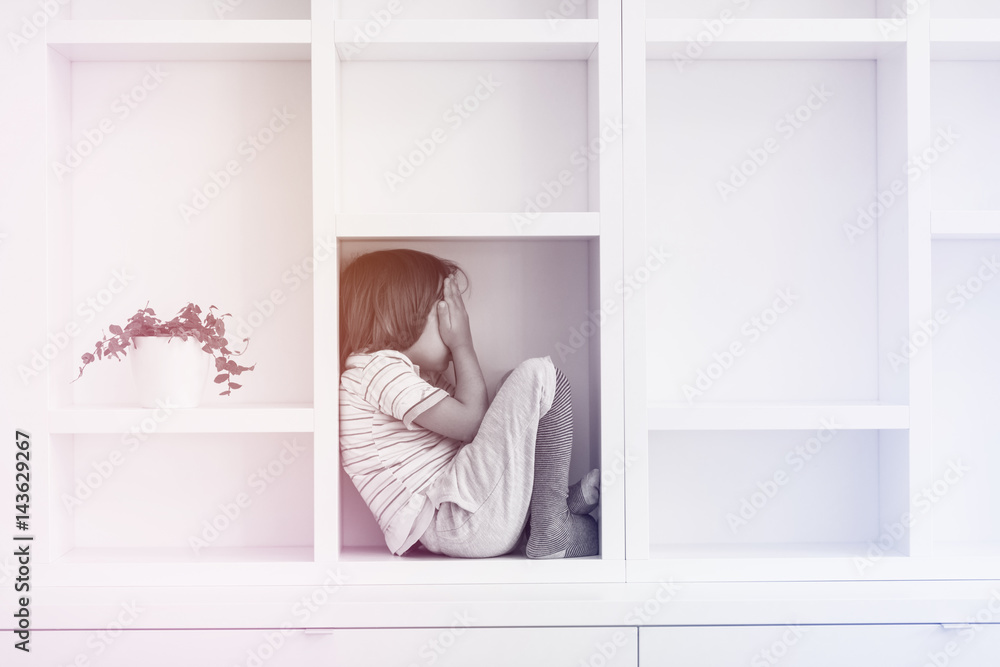 young boy posing on a shelf