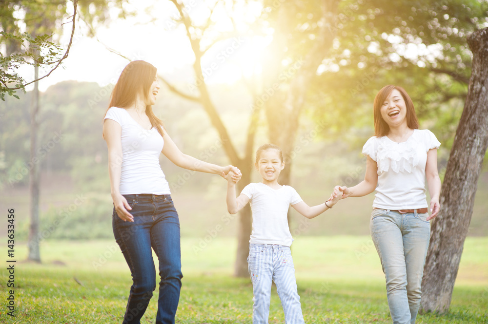 Fototapeta premium Asian family playing outdoors