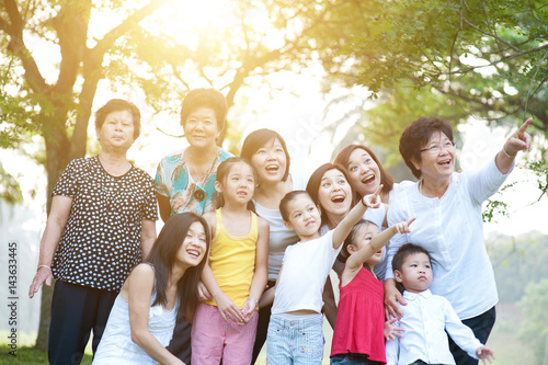 Large group of Asian multi generations family having fun outdoors
