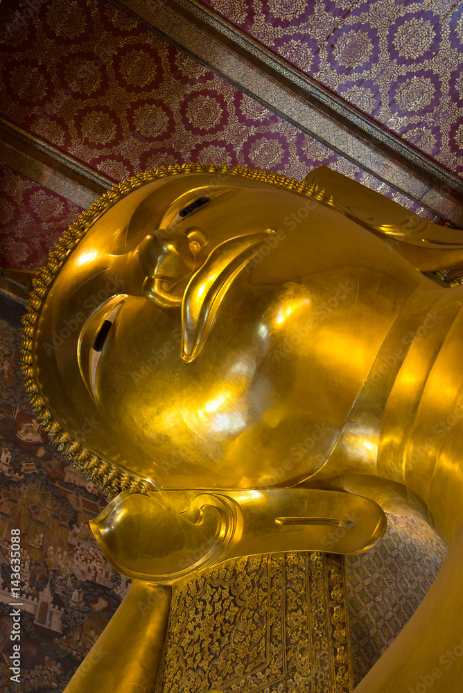 Head of the reclining Buddha close up in Buddhist temple Wat Pho, Bangkok, Thailand