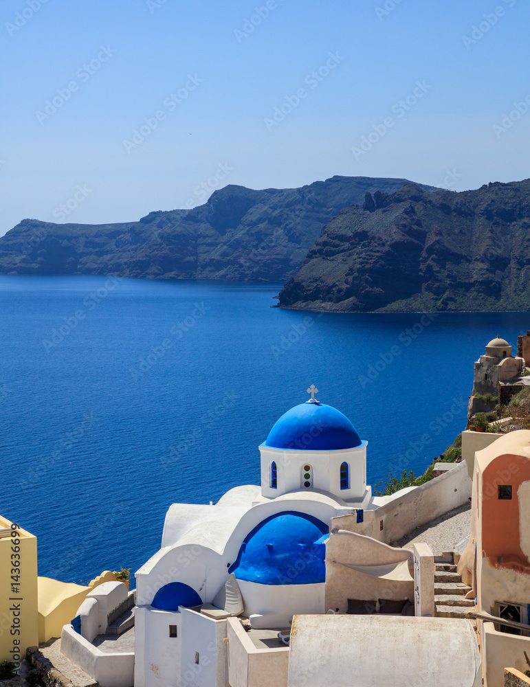 Fototapeta premium White church with blue dome in Santorini, Greece