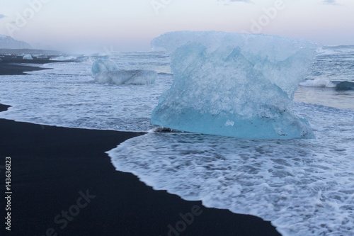 Natural black sand beach with Ice breaking on top, Iceland natural winter season landscape background photo