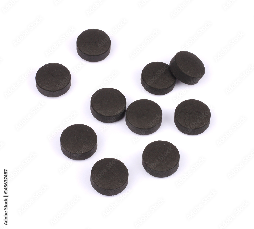 activated carbon pills isolated on white background