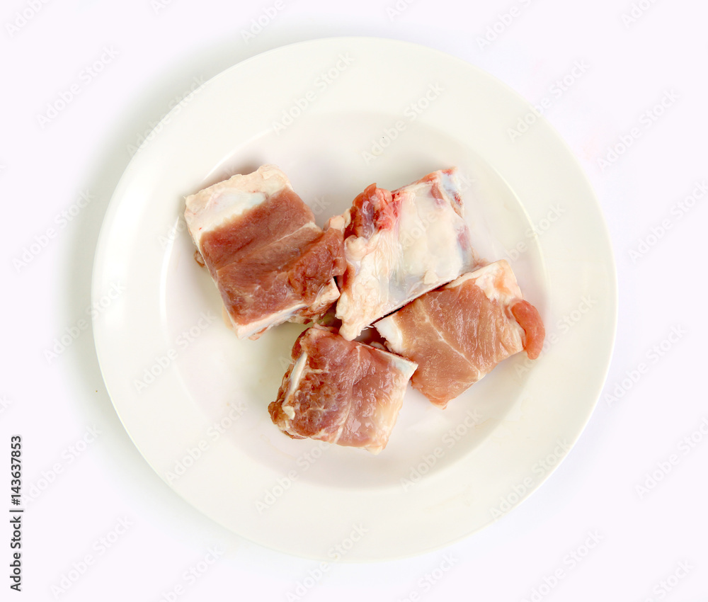 Raw Pork Ribs in white plate on white background Raw Pork Ribs in white plate on white background