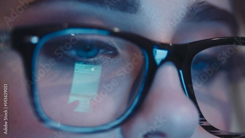Wallpaper Mural Close up view of blue woman’s eyes in the glasses looking into the phone’s screen. Screen light reflecting in the glasses. Wonderful makeup. Being online. Torontodigital.ca
