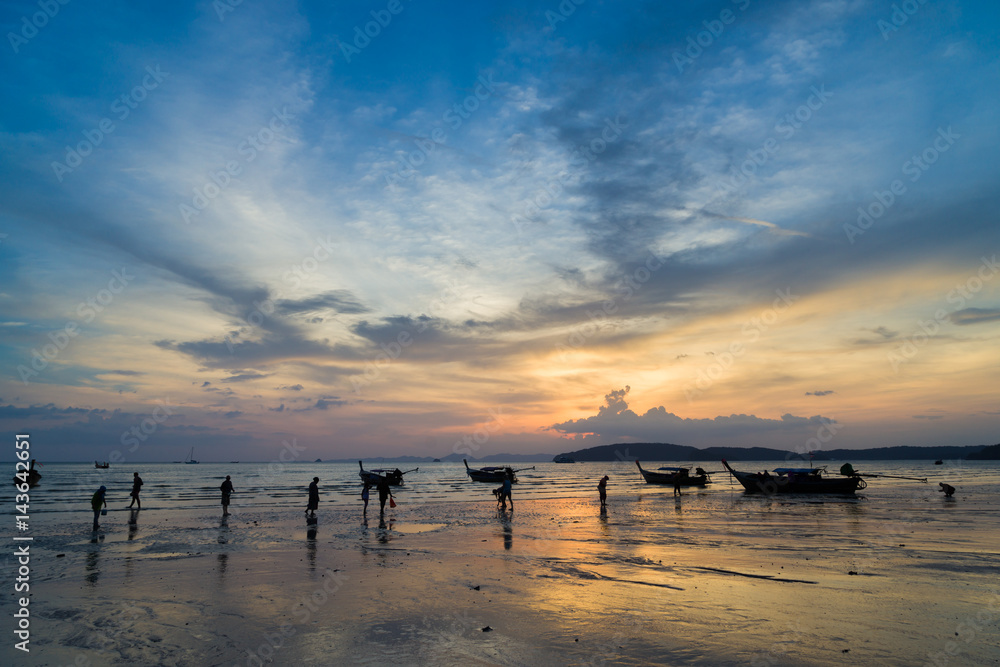 People on the Ao Nang beach at sunset in Krabi