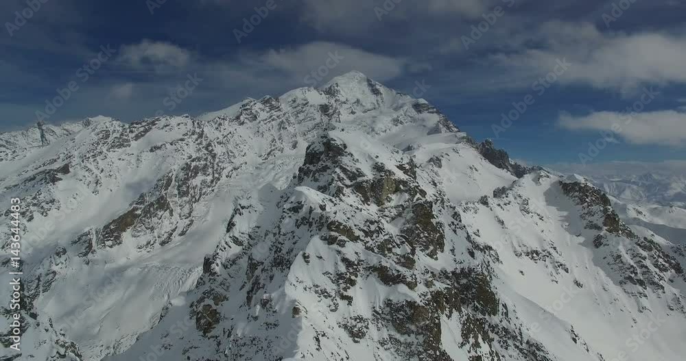 Aerial survey of the snow-capped peaks of the mountains. Video in 4K Aerial survey of the snow-capped peaks of the mountains. Video in 4K