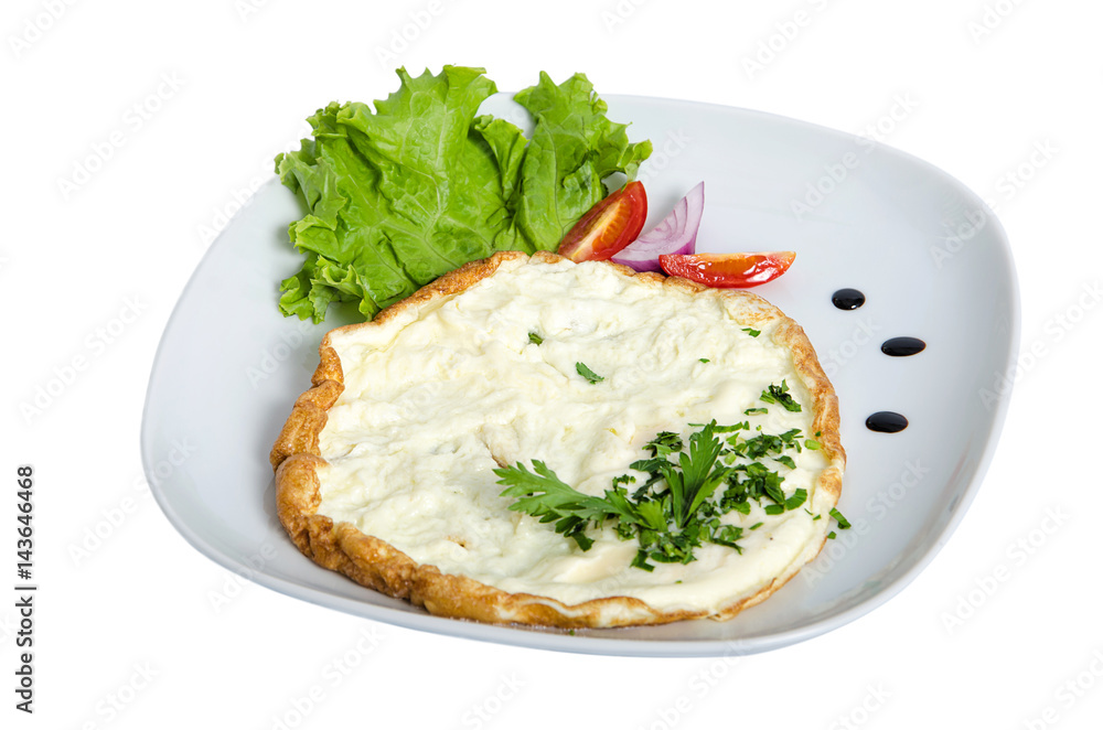 Omelette on white plate isolated with salad and tomato