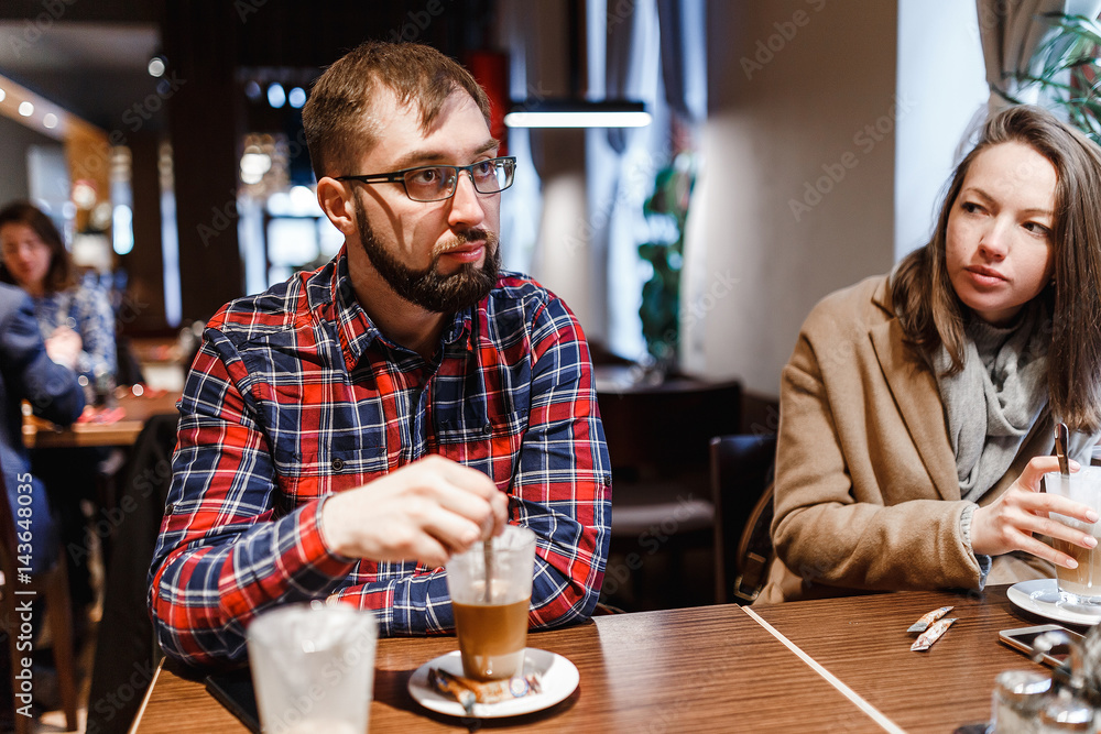 friends talking and drinking coffee in cafe