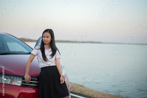 young woman sad and car at roadside and sunset time