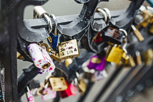 Padlocks as symbol of love on a fence of a bridge in Prague