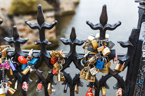 Photography Padlocks as symbol of love on a fence of a bridge in Prague