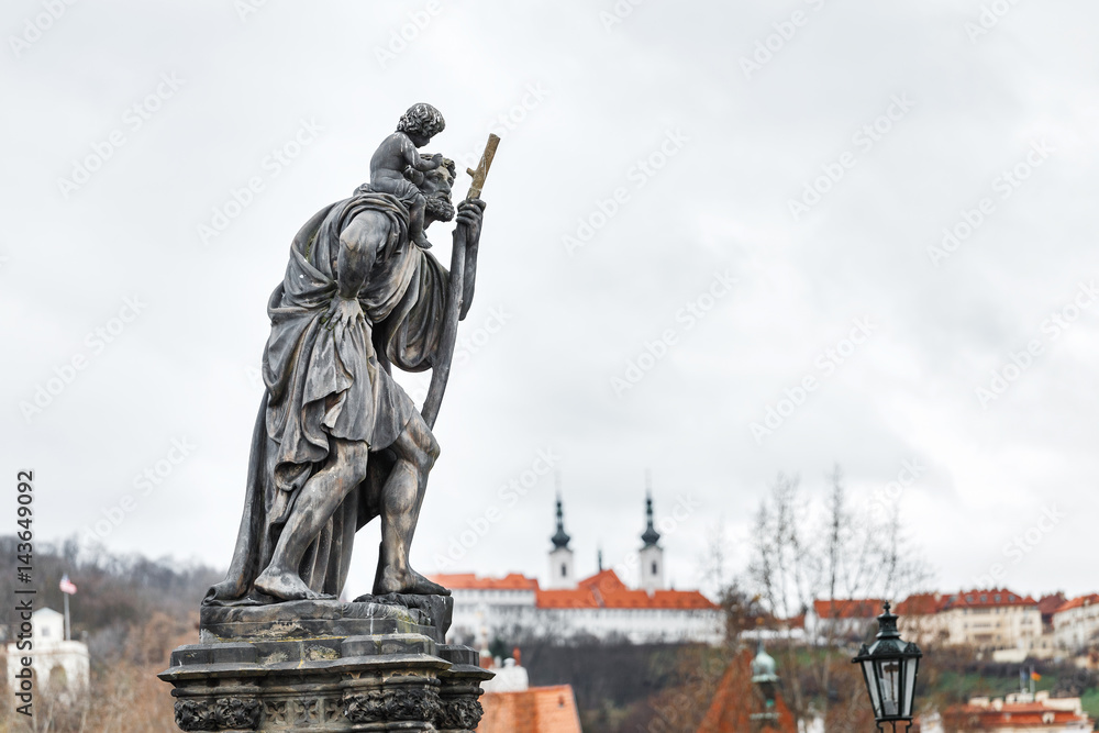 Obraz premium Statue of Child Christus at the shoulder of saint Christopher, Patron of wanderers, navigators and travelers on Charles Bridge, Prague