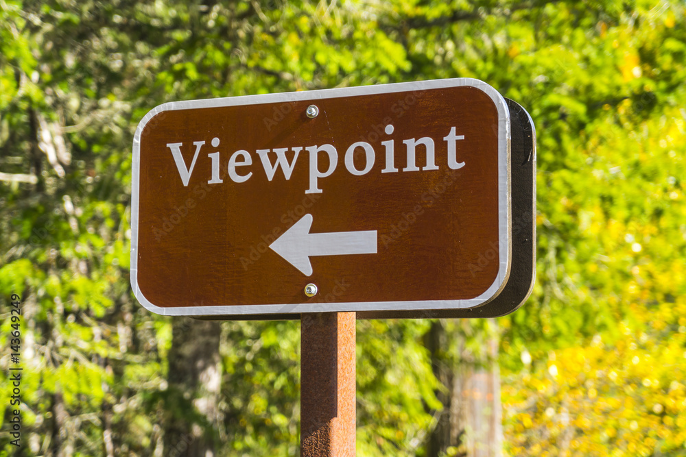 viewpoint sign  and arrow with forest background.
