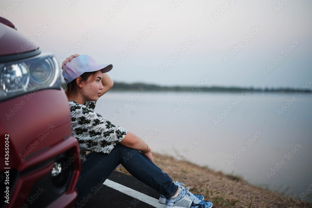 young woman sad and car at roadside and sunset time young woman sad and car at roadside and sunset time