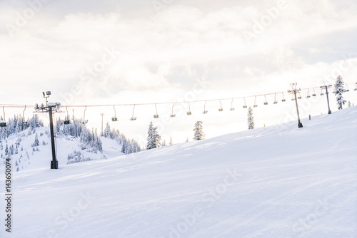 beautiful ski lift over snow mountain in ski resort with blue sky background. © checubus