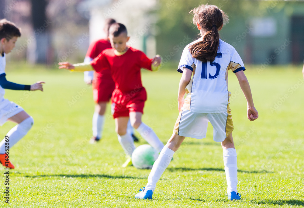 Obraz premium Kids soccer football - children players match on soccer field