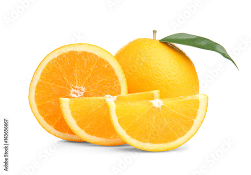Ripe cutting orange with green leaf isolated on white