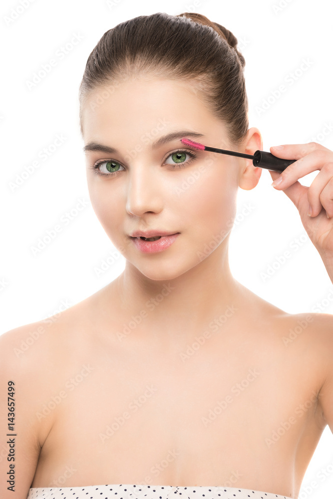 Eye make up apply. Mascara applying closeup, long lashes. Mascara brush. Portrait of beautiful young brunette woman with perfect fresh clean face skin. Eyelashes extensions. Make-up for green eyes Eye make up apply. Mascara applying closeup, long lashes. Mascara brush. Portrait of beautiful young brunette woman with perfect fresh clean face skin. Eyelashes extensions. Make-up for green eyes