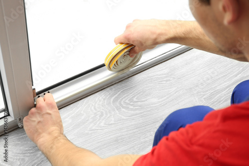 Young worker applying rubbe...