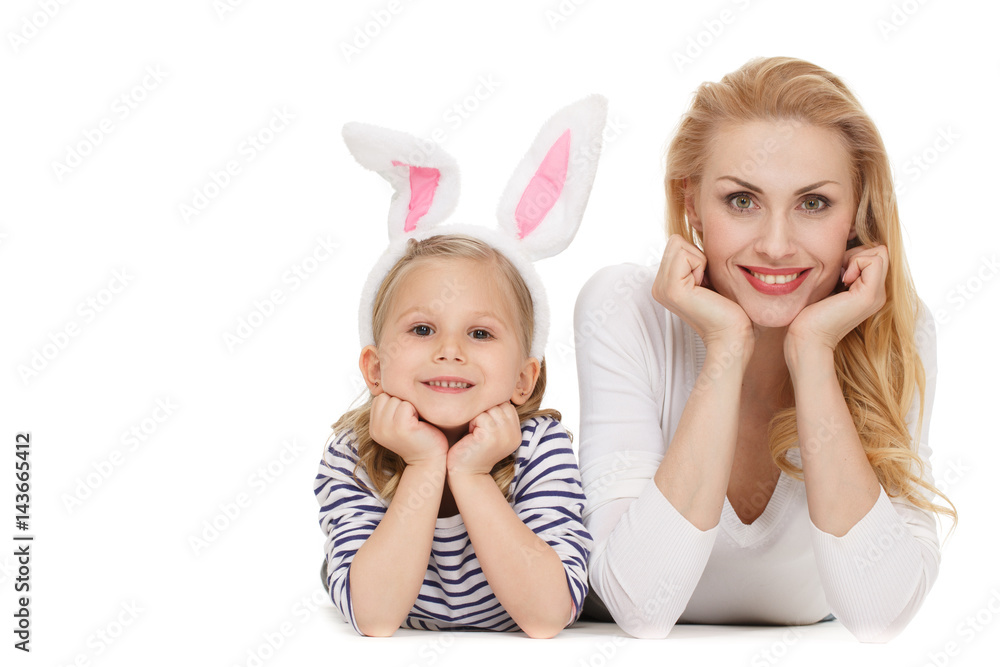 Resting. Portrait of pretty mother and daughter cupping their faces with their hands looking to the camera smiling at the studio isolated on white. Resting. Portrait of pretty mother and daughter cupping their faces with their hands looking to the camera smiling at the studio isolated on white.