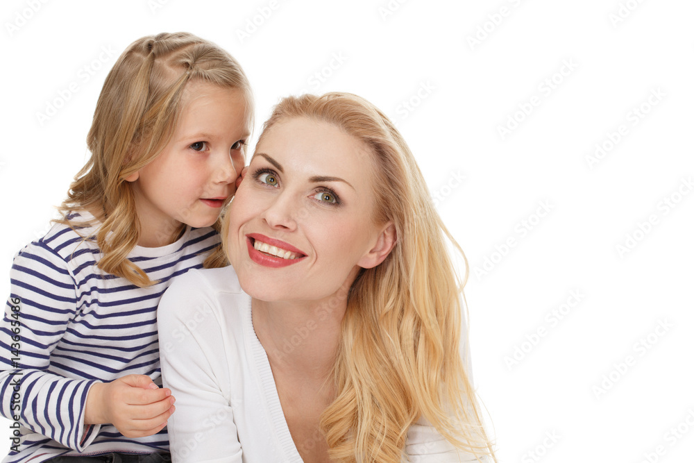 Tell her everything. Portrait of a little cute girl whispering to her mother at the studio on white background. Tell her everything. Portrait of a little cute girl whispering to her mother at the studio on white background.