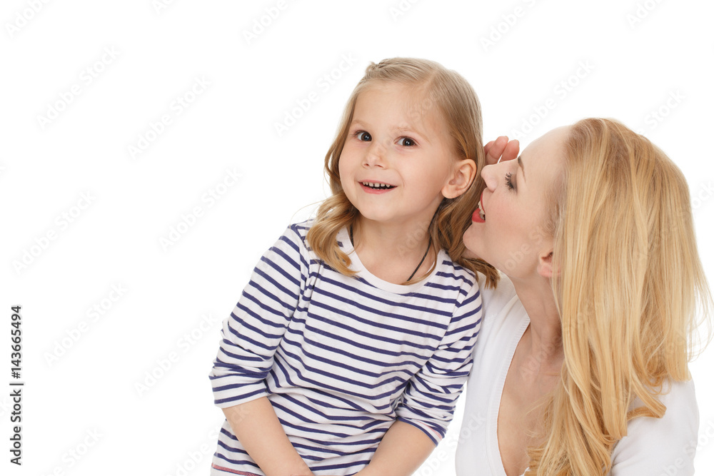Can not believe. Studio shot of a cheerful mother whispering secrets to her surprised little daughter isolated on white. Can not believe. Studio shot of a cheerful mother whispering secrets to her surprised little daughter isolated on white.