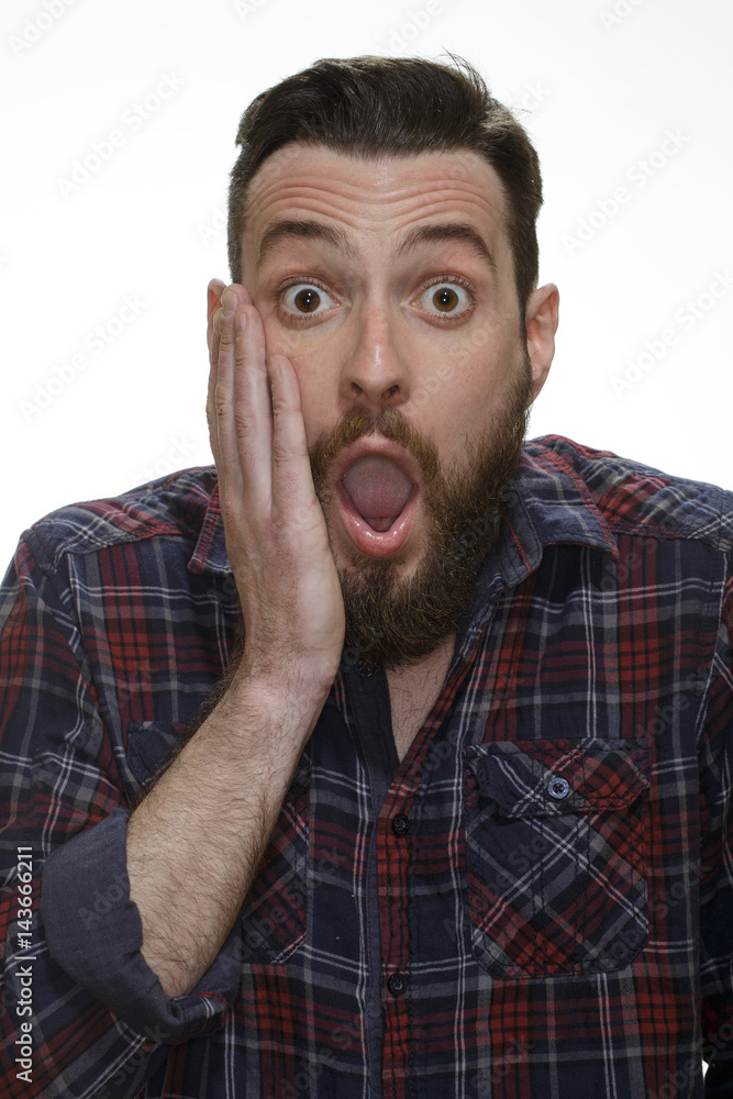 Surprise! Studio shot of a shocked bearded guy looking to the camera surprised with his mouth opened isolated on white. Surprise! Studio shot of a shocked bearded guy looking to the camera surprised with his mouth opened isolated on white.