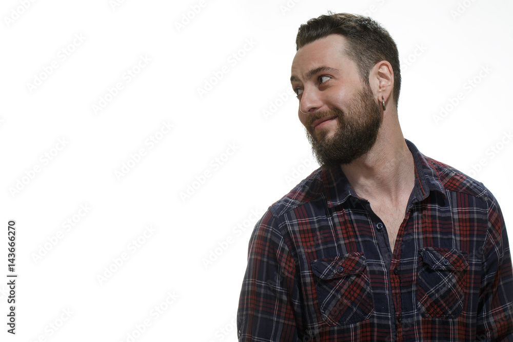 Just smile. Portrait of a cheerful bearded hipster smiling looking at the copyspace on the side at the studio isolated on white. Just smile. Portrait of a cheerful bearded hipster smiling looking at the copyspace on the side at the studio isolated on white.