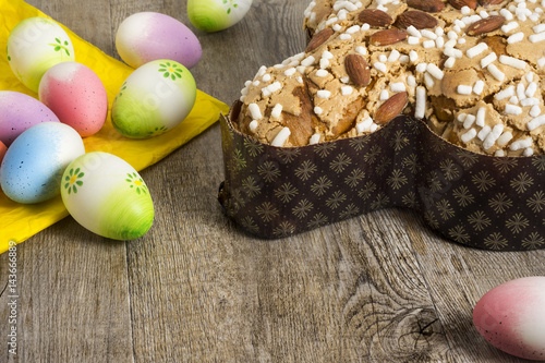 Easter eggs, colomba italian cake wooden background