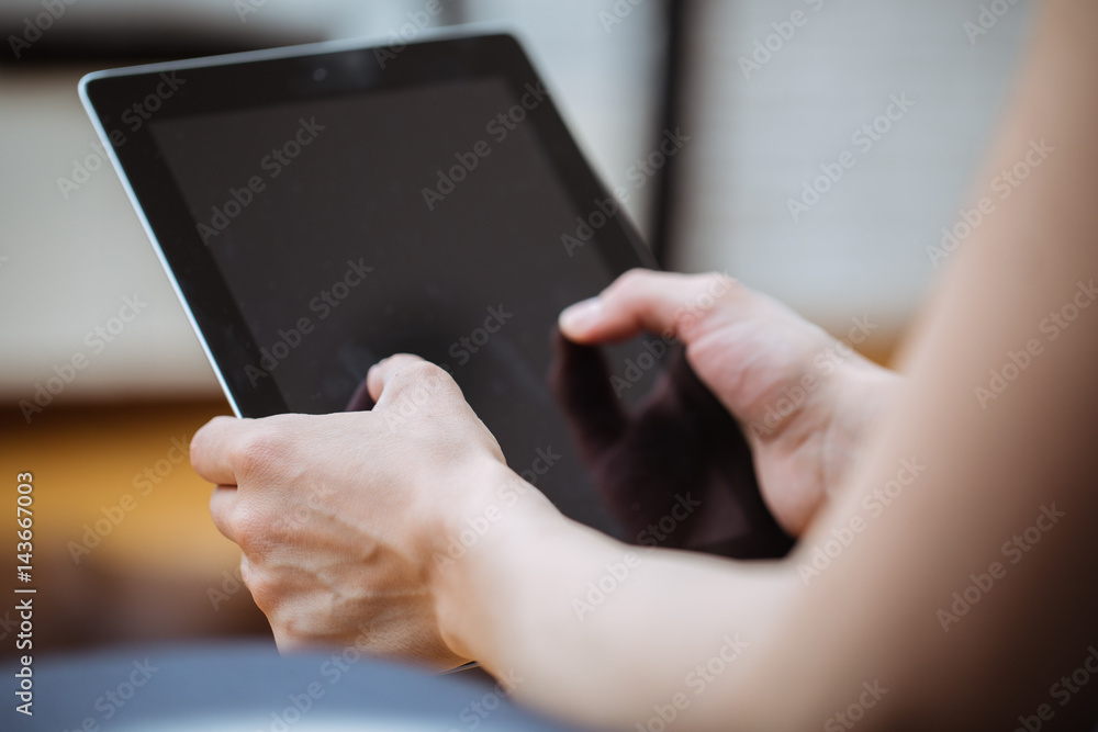Close-up of digital tablet in a young womans hands Close-up of digital tablet in a young womans hands