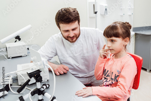 Orthoptics. Pleoptics. Doctor explains how to use ophthalmic equipment. Eye training. Vision rehabilitation. photo