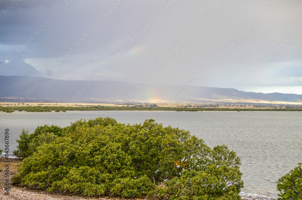 Storm front moving over Port Pirie bay bringing rain and rainbows to the Flinders Ranges