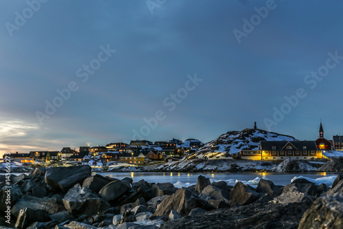 Nuuk city old harbor sunset view with stones and icebergs, Greenland