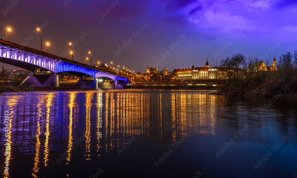 Zamek Królewski - Royal Castle in Warsaw, with a bridge and river reflection as seen by night