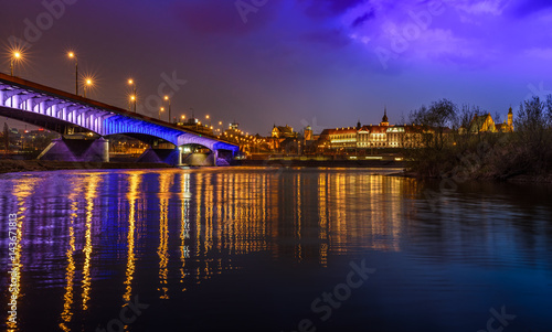 Zamek Królewski - Royal Castle in Warsaw, with a bridge and river reflection as seen by night