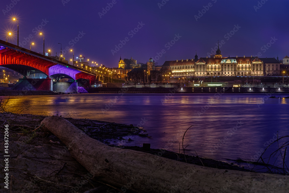 Zamek Królewski - Royal Castle in Warsaw as seen by night with a bridge and a river reflection