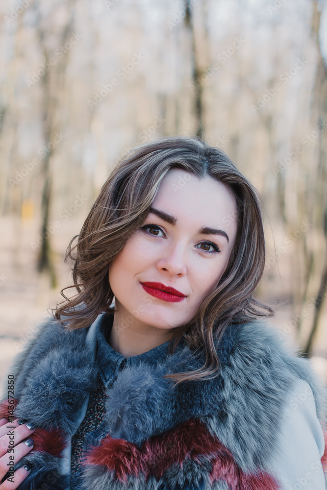 Portrait of a happy enamored girl in anticipation of a beloved man in the park Portrait of a happy enamored girl in anticipation of a beloved man in the park