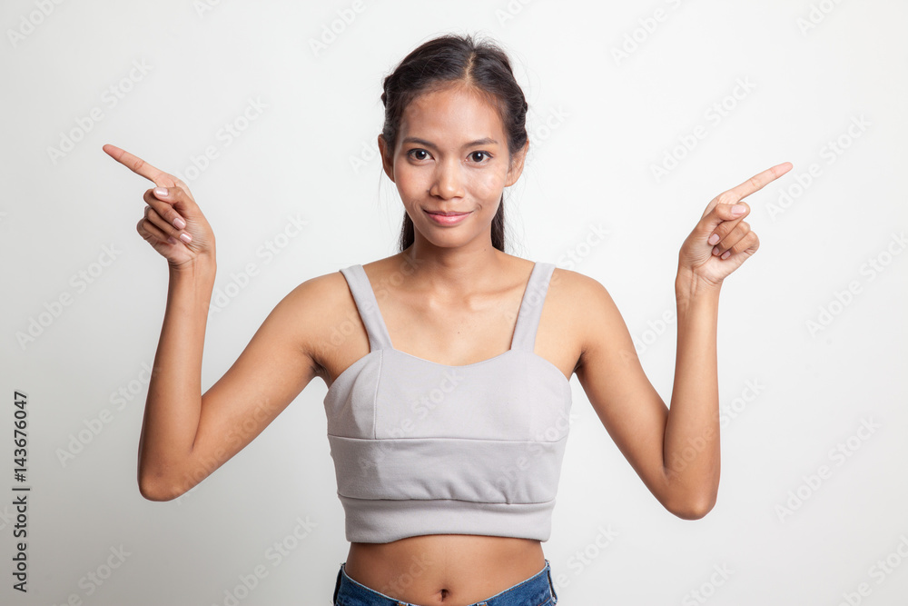 Young Asian woman point to left and right. Young Asian woman point to left and right.