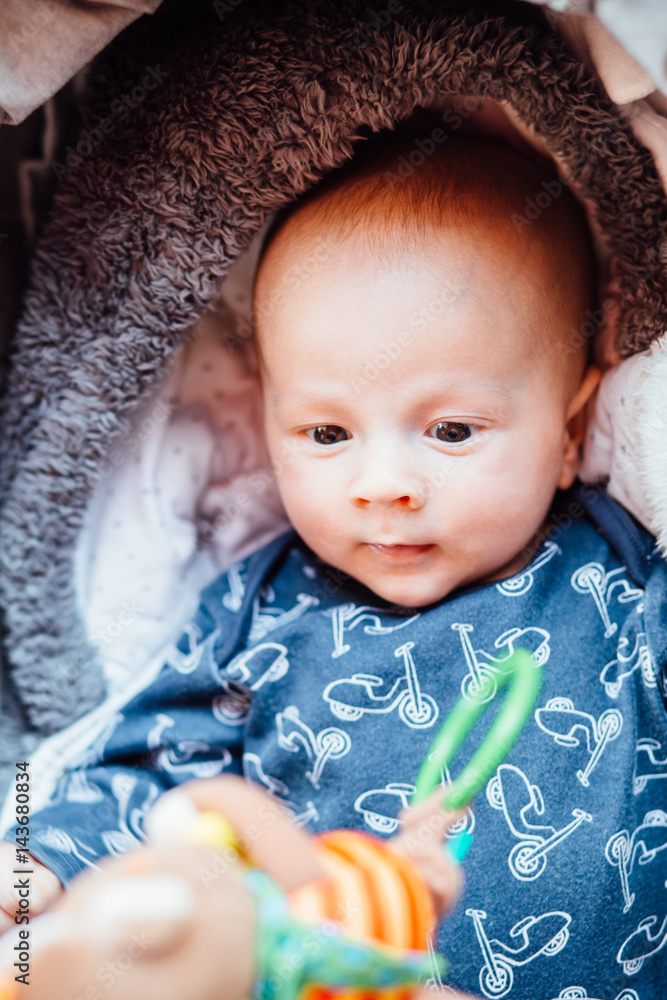 Top vew of cute newborn baby boy playing with toy. Top vew of cute newborn baby boy playing with toy.