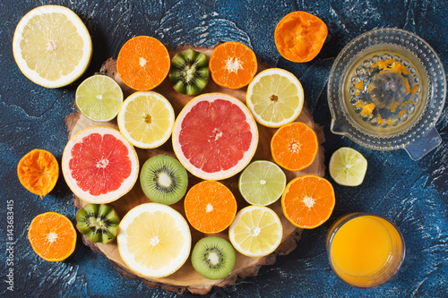 Fruits rich in vitamin C on the dark blue table