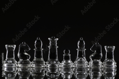 Pawn on king position of chess with beautiful highlight on black background - leadership, aspiration, competitive and business concept